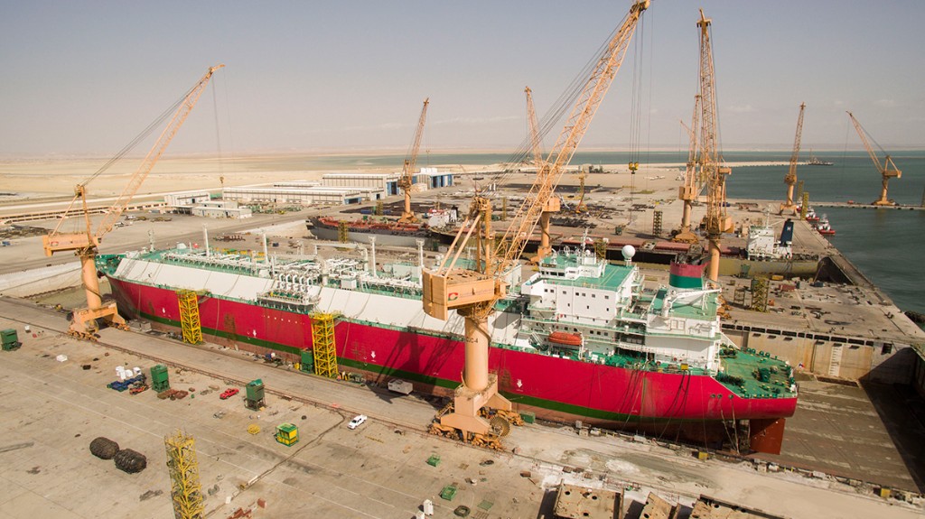 Large merchant vessel in dry dock for repair and maintenance.