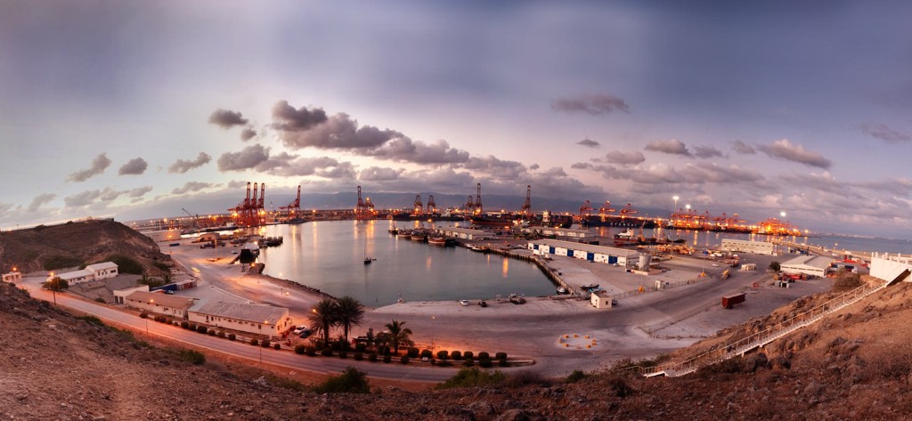 Salalah Free Zone and port-linked industrial landscape at dusk.