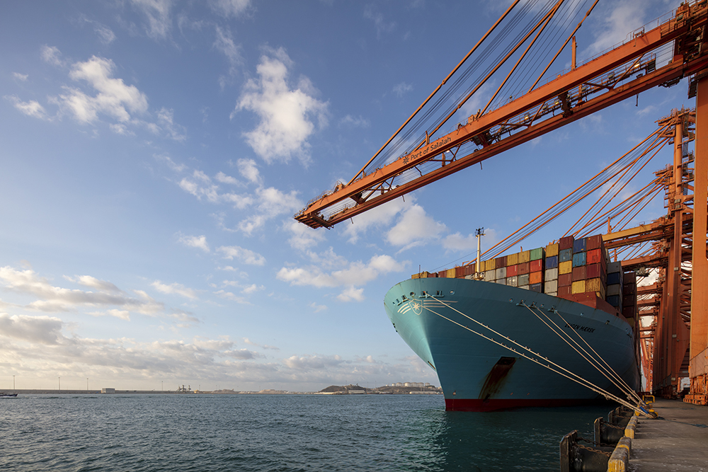 Salalah port harbour with gantry cranes and shipping activity.