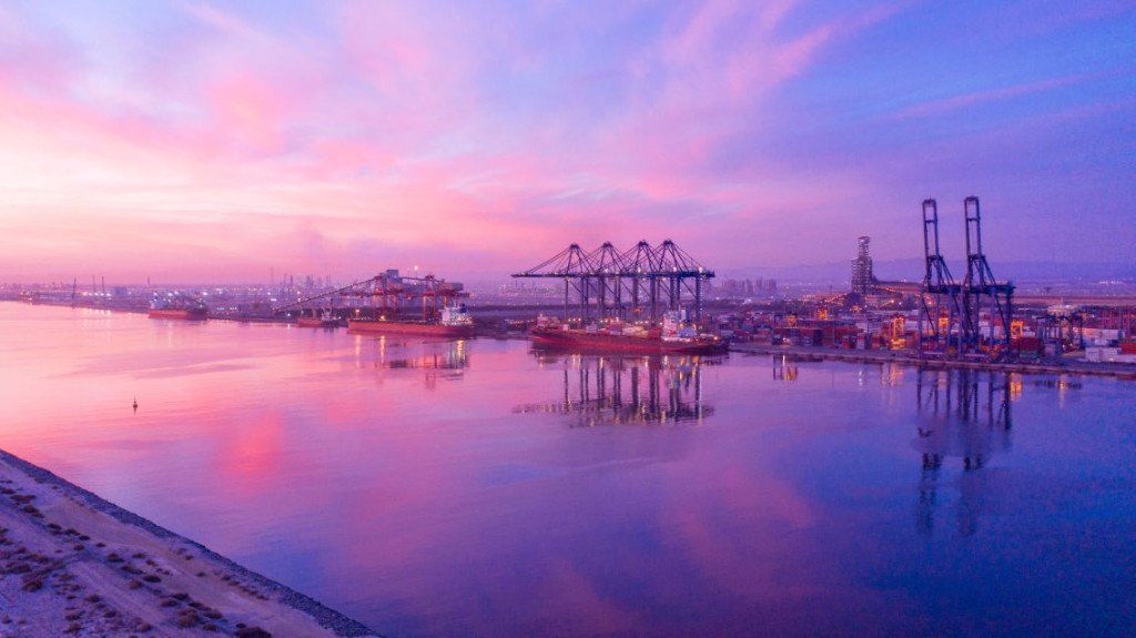 Port of Sohar with vessels, cranes, and terminal operations.