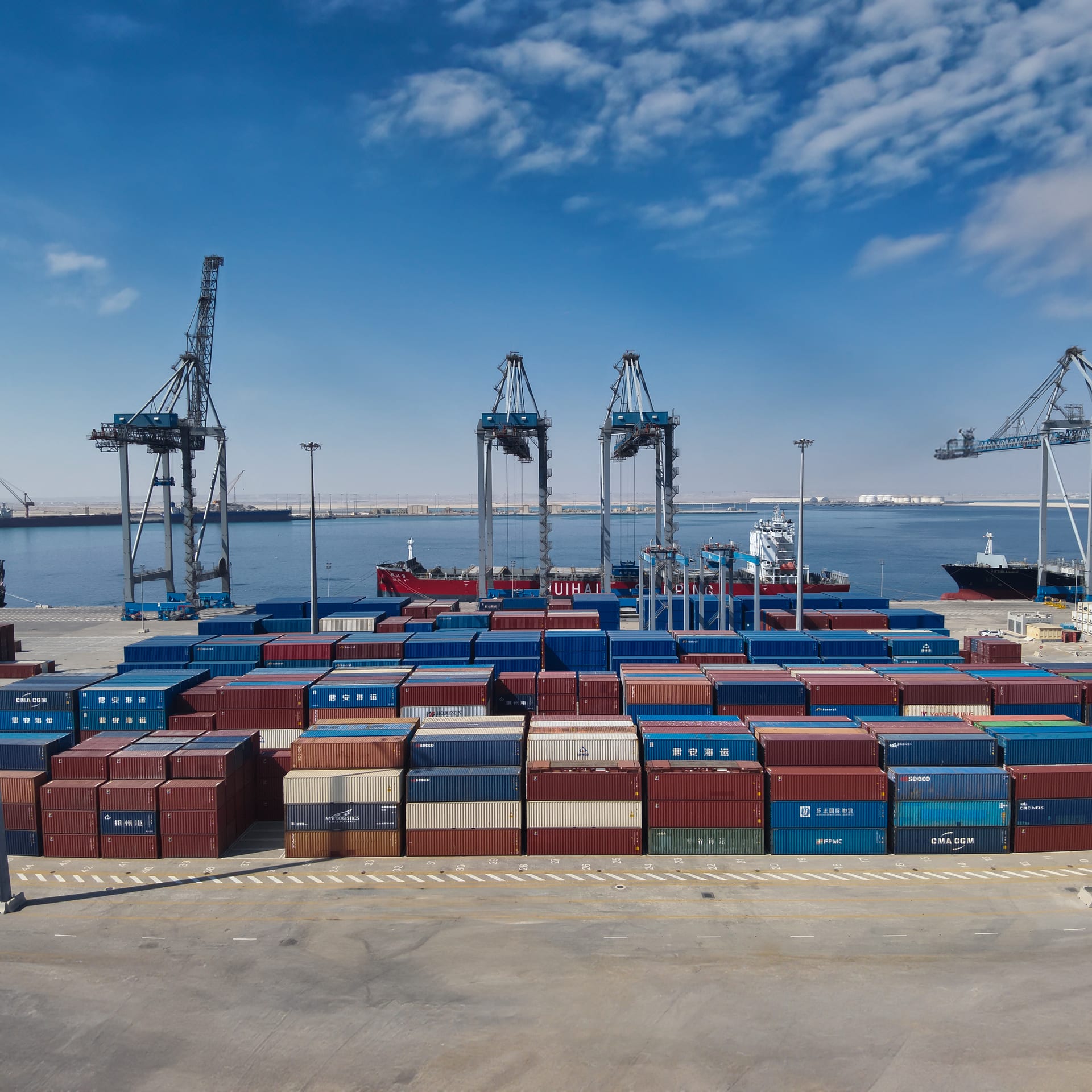 Container terminal with gantries and stacked containers at Duqm.